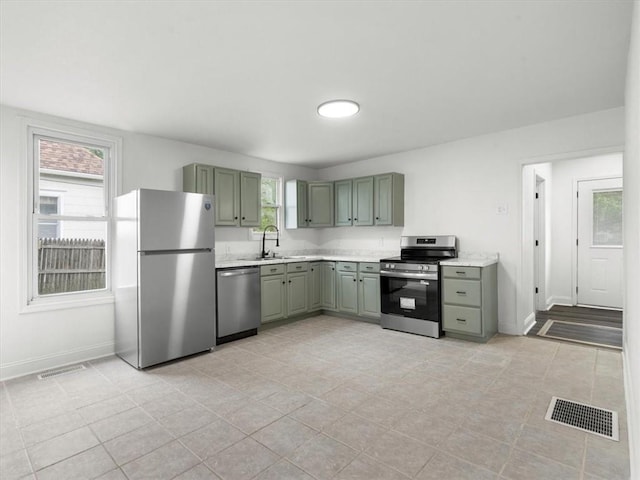 kitchen with light countertops, appliances with stainless steel finishes, and visible vents