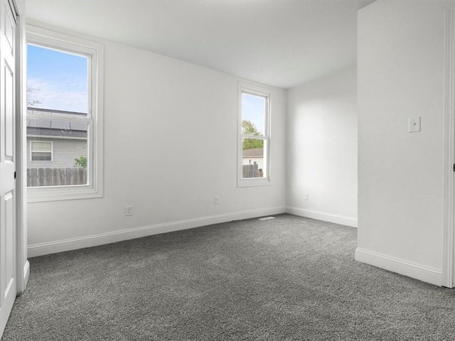 carpeted spare room with baseboards