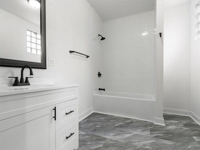 bathroom featuring baseboards, marble finish floor, vanity, and shower / washtub combination