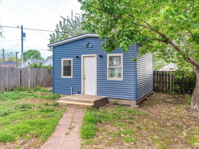 view of outbuilding with a fenced backyard and an outbuilding