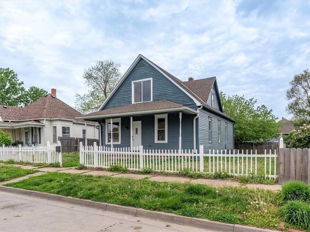 bungalow-style house with roof with shingles and covered porch