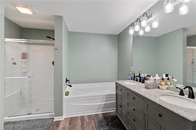7912 N Poplar Ct, Kansas City, MO 64119 - bathroom with wood finished floors, a bath, a stall shower, and double vanity