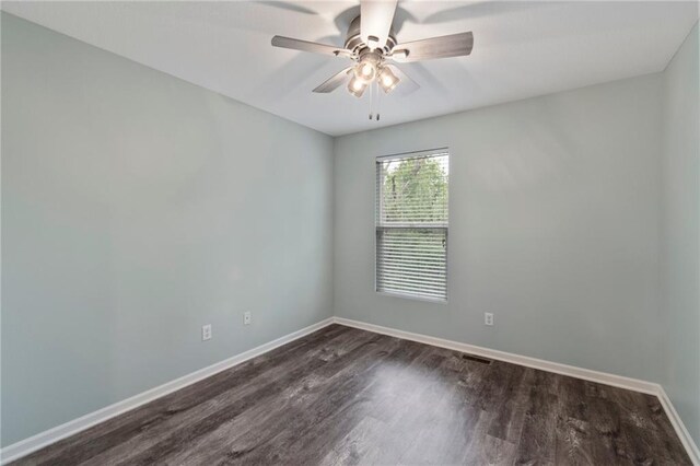 7912 N Poplar Ct, Kansas City, MO 64119 - unfurnished room with dark wood finished floors, baseboards, and ceiling fan