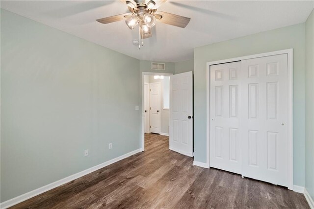 7912 N Poplar Ct, Kansas City, MO 64119 - unfurnished bedroom featuring baseboards, wood finished floors, a closet, and ceiling fan