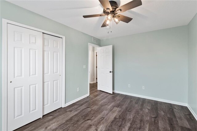 7912 N Poplar Ct, Kansas City, MO 64119 - unfurnished bedroom with baseboards, dark wood-type flooring, a closet, and a ceiling fan