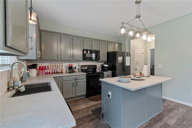7912 N Poplar Ct, Kansas City, MO 64119 - kitchen with black appliances, a sink, dark wood-style floors, gray cabinets, and light countertops