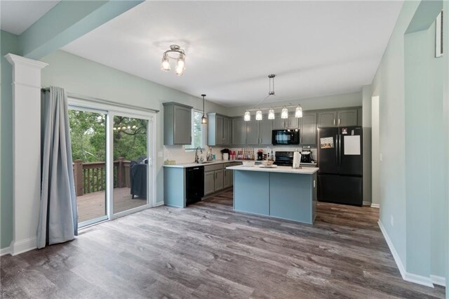 7912 N Poplar Ct, Kansas City, MO 64119 - kitchen with black appliances, gray cabinetry, a sink, dark wood-type flooring, and light countertops
