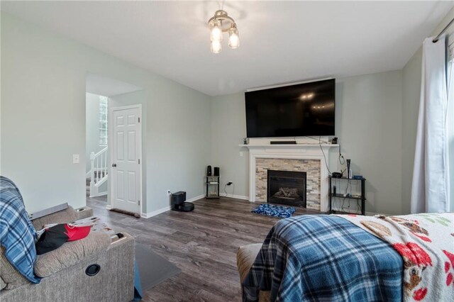 7912 N Poplar Ct, Kansas City, MO 64119 - living area with wood finished floors, stairway, a fireplace, and baseboards