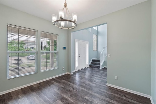 7912 N Poplar Ct, Kansas City, MO 64119 - spare room with a chandelier, dark wood-style floors, stairway, and baseboards