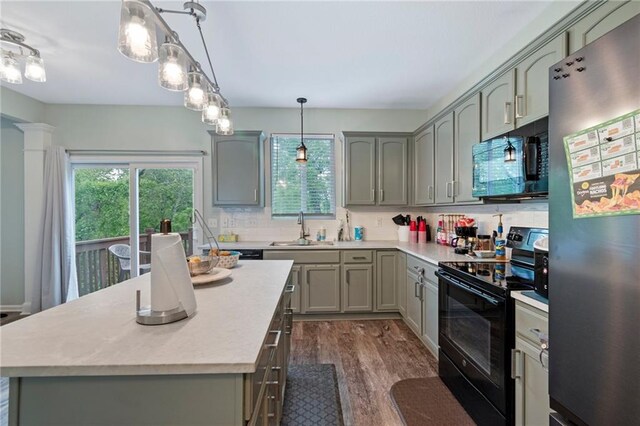 7912 N Poplar Ct, Kansas City, MO 64119 - kitchen featuring black appliances, healthy amount of natural light, light countertops, and a sink