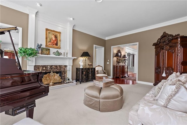 carpeted living area with a premium fireplace, baseboards, and crown molding