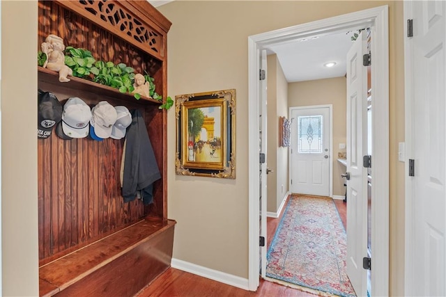mudroom with baseboards and wood finished floors