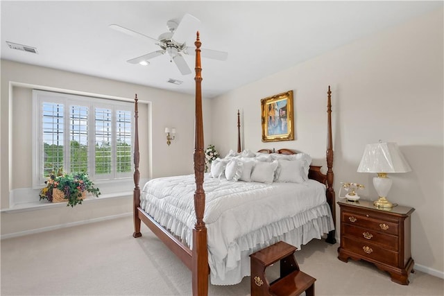 bedroom with light colored carpet, visible vents, and ceiling fan