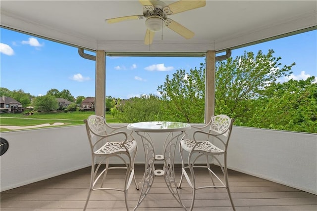 sunroom / solarium featuring ceiling fan