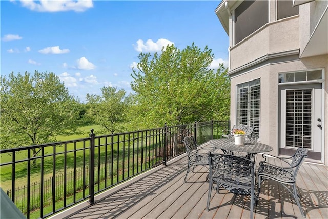 wooden terrace featuring outdoor dining space