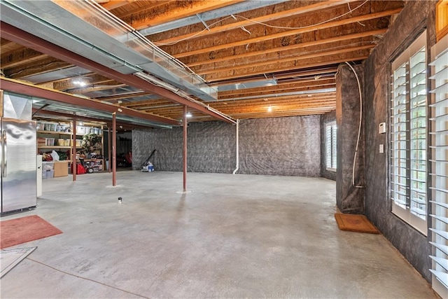 basement featuring freestanding refrigerator