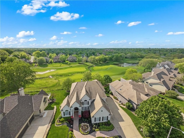 drone / aerial view with a water view and view of golf course
