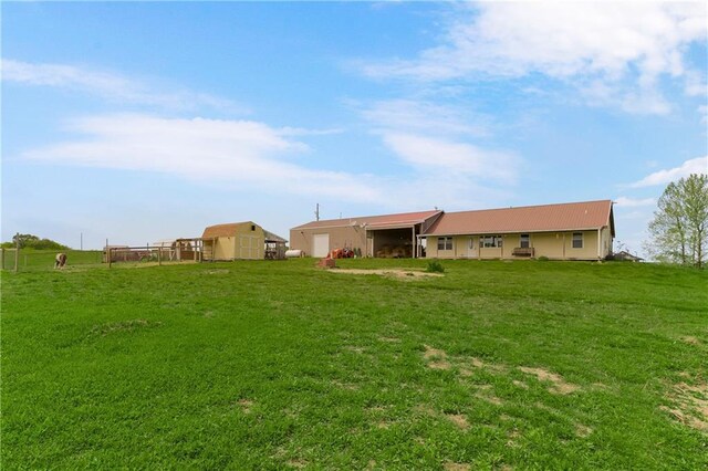 7934 SW James Lee Rd, Polo, MO 64671 - back of property featuring a lawn and a metal roof