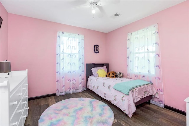 7934 SW James Lee Rd, Polo, MO 64671 - bedroom featuring multiple windows, dark wood finished floors, and a ceiling fan