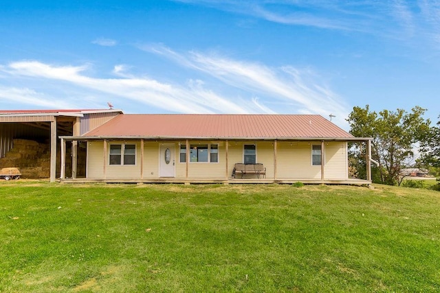 7934 SW James Lee Rd, Polo, MO 64671 - rear view of property featuring a lawn and a metal roof