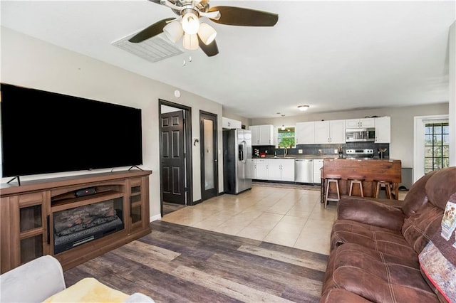 7934 SW James Lee Rd, Polo, MO 64671 - living room featuring a ceiling fan and light wood finished floors