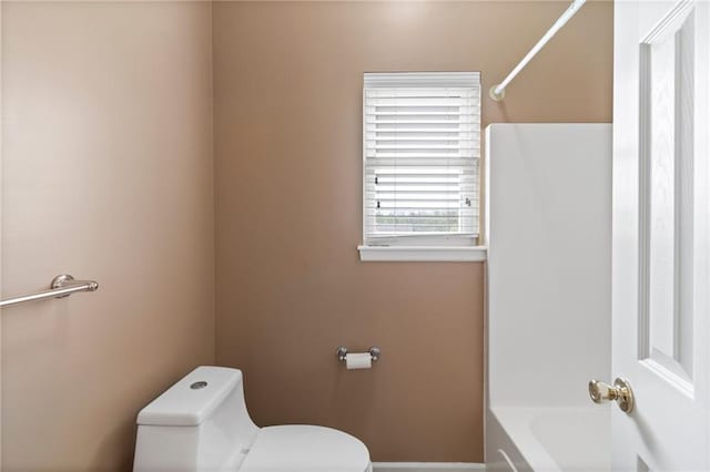 full bathroom featuring toilet and baseboards