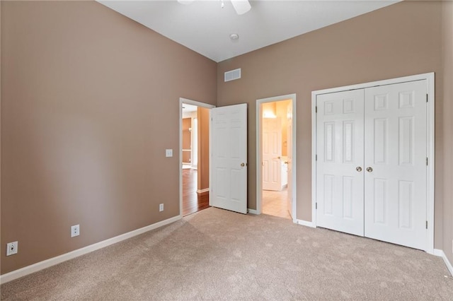unfurnished bedroom featuring carpet, a ceiling fan, baseboards, visible vents, and a closet