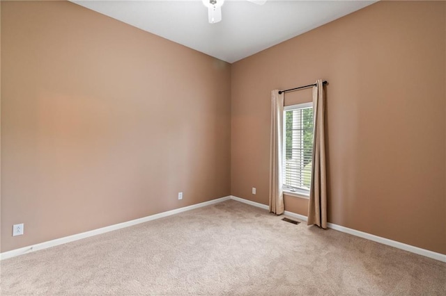 unfurnished room featuring a ceiling fan, baseboards, visible vents, and light carpet