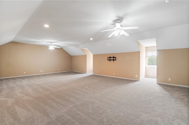 bonus room featuring baseboards, ceiling fan, and vaulted ceiling
