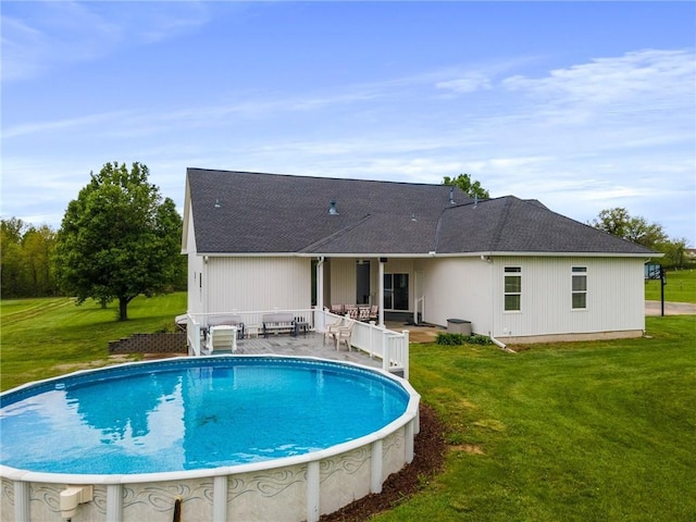 outdoor pool featuring a lawn