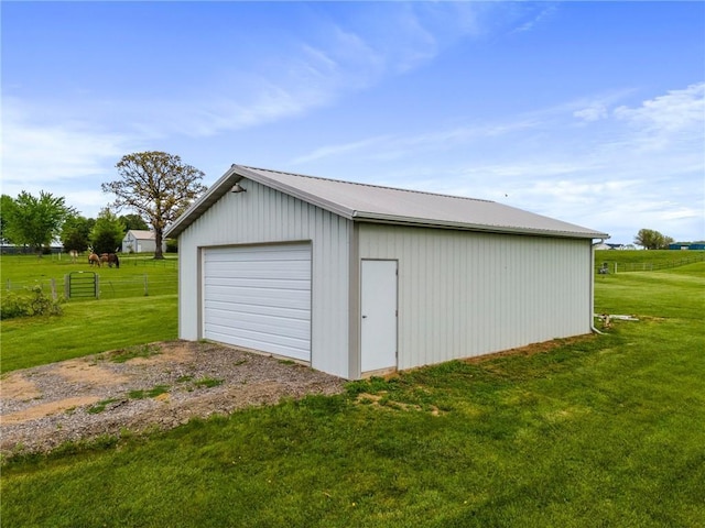detached garage with fence and driveway