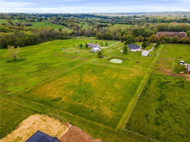 birds eye view of property with a rural view