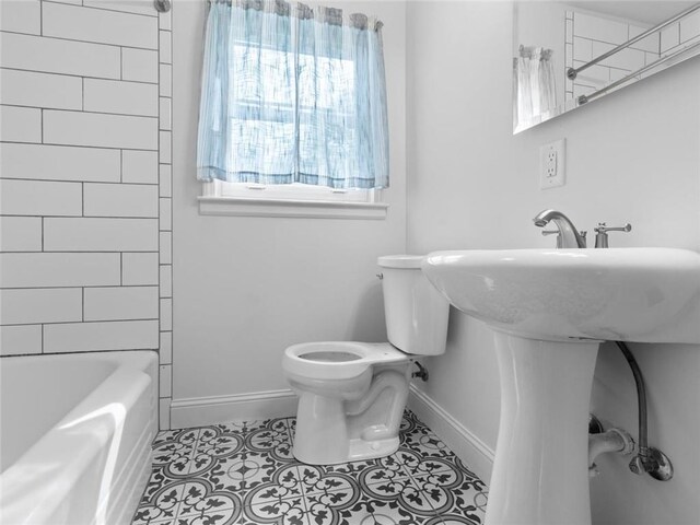 full bathroom featuring baseboards, shower / bathtub combination, tile patterned floors, and toilet
