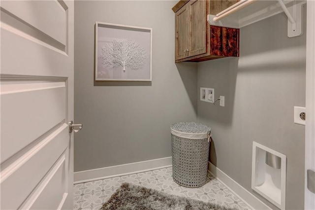 laundry room with baseboards, hookup for a washing machine, and cabinet space