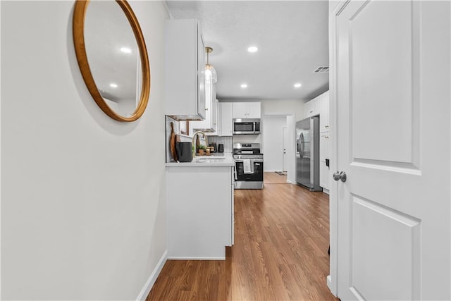 2521 W 47th Ter, Westwood, KS 66205 - corridor with a sink, wood finished floors, baseboards, and recessed lighting