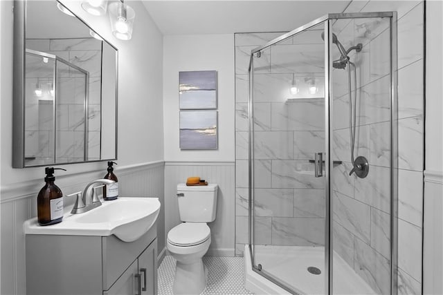 2521 W 47th Ter, Westwood, KS 66205 - full bathroom featuring vanity, toilet, wainscoting, a shower stall, and tile patterned floors