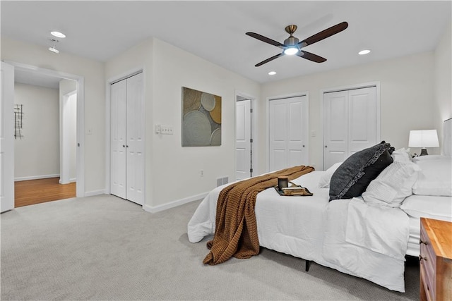 2521 W 47th Ter, Westwood, KS 66205 - bedroom featuring two closets, carpet flooring, baseboards, recessed lighting, and ceiling fan