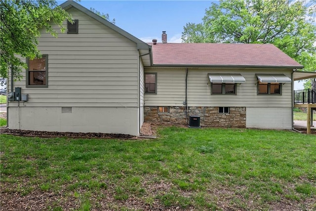 2521 W 47th Ter, Westwood, KS 66205 - rear view of house featuring a yard, central air condition unit, a chimney, and roof with shingles
