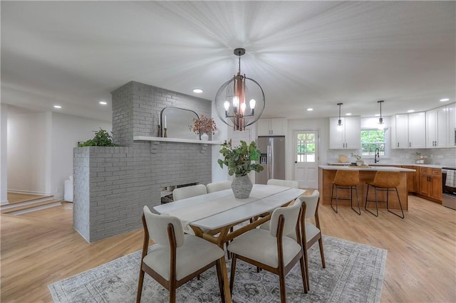 dining room with recessed lighting, a chandelier, and light wood-style flooring