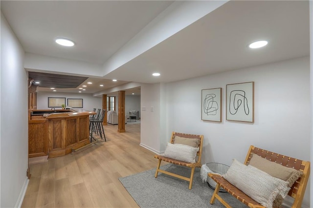bar with indoor wet bar, recessed lighting, baseboards, and light wood-style flooring