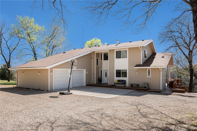 23801 Evans Rd, Tonganoxie, KS 66086 - rear view of property featuring a garage, concrete driveway, and roof with shingles