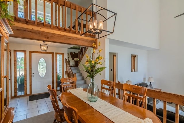 23801 Evans Rd, Tonganoxie, KS 66086 - tiled dining room with stairs, a towering ceiling, and a chandelier