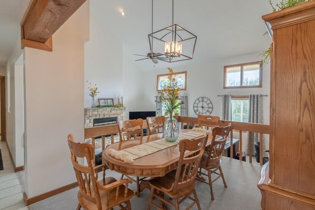 23801 Evans Rd, Tonganoxie, KS 66086 - dining area with a stone fireplace, a chandelier, baseboards, and high vaulted ceiling