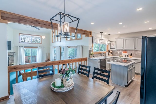 23801 Evans Rd, Tonganoxie, KS 66086 - dining area with plenty of natural light, light wood-style flooring, recessed lighting, ceiling fan, and a chandelier