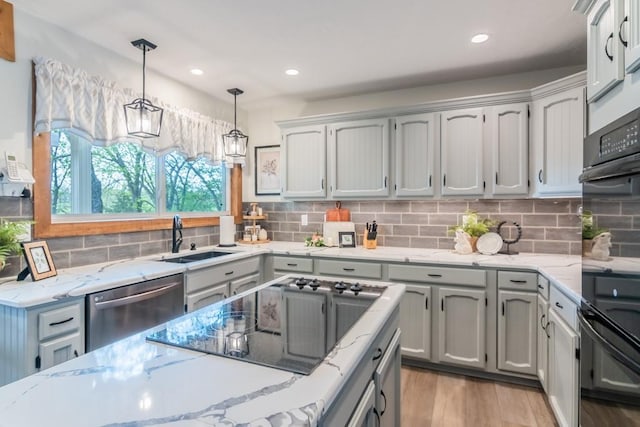 23801 Evans Rd, Tonganoxie, KS 66086 - kitchen featuring a sink, light wood finished floors, black appliances, decorative light fixtures, and tasteful backsplash