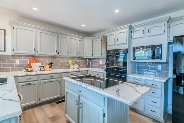 23801 Evans Rd, Tonganoxie, KS 66086 - kitchen featuring light wood-style flooring, black appliances, backsplash, and recessed lighting