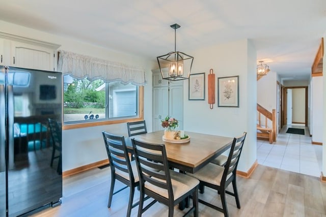 23801 Evans Rd, Tonganoxie, KS 66086 - dining area featuring a chandelier, light wood-style floors, and baseboards