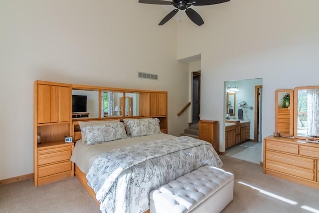 23801 Evans Rd, Tonganoxie, KS 66086 - bedroom featuring a towering ceiling, light colored carpet, baseboards, ceiling fan, and ensuite bath