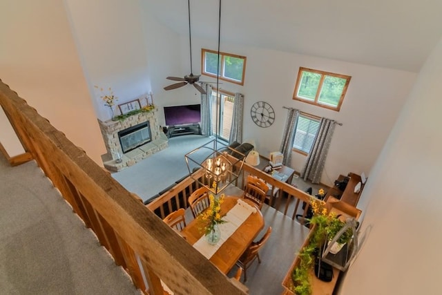 23801 Evans Rd, Tonganoxie, KS 66086 - carpeted living area featuring a fireplace, ceiling fan, and a high ceiling