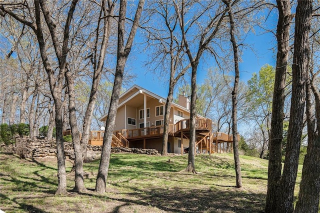 23801 Evans Rd, Tonganoxie, KS 66086 - rear view of property featuring stairs, a wooden deck, and a yard